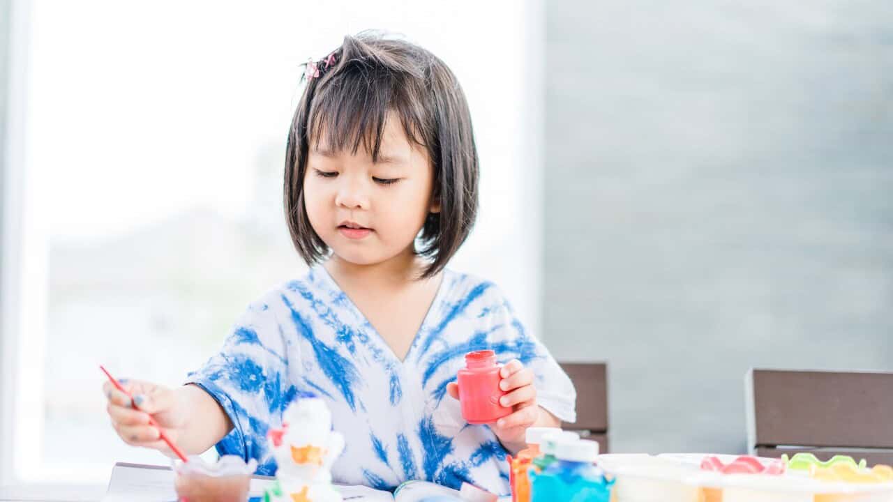 Little girl painting.